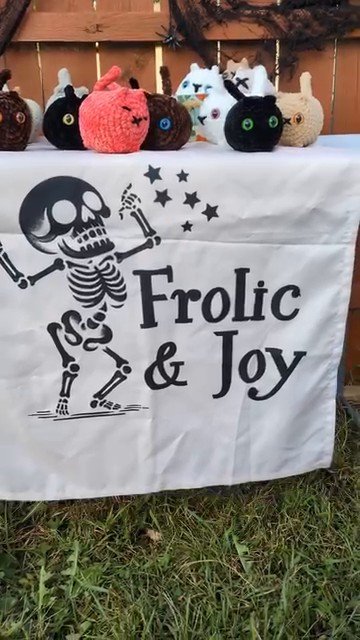 Frolic and Joy skeleton banner at a craft market booth