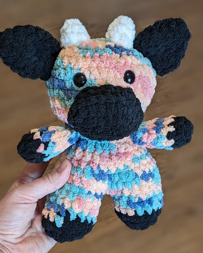 Colorful pastel crochet cow