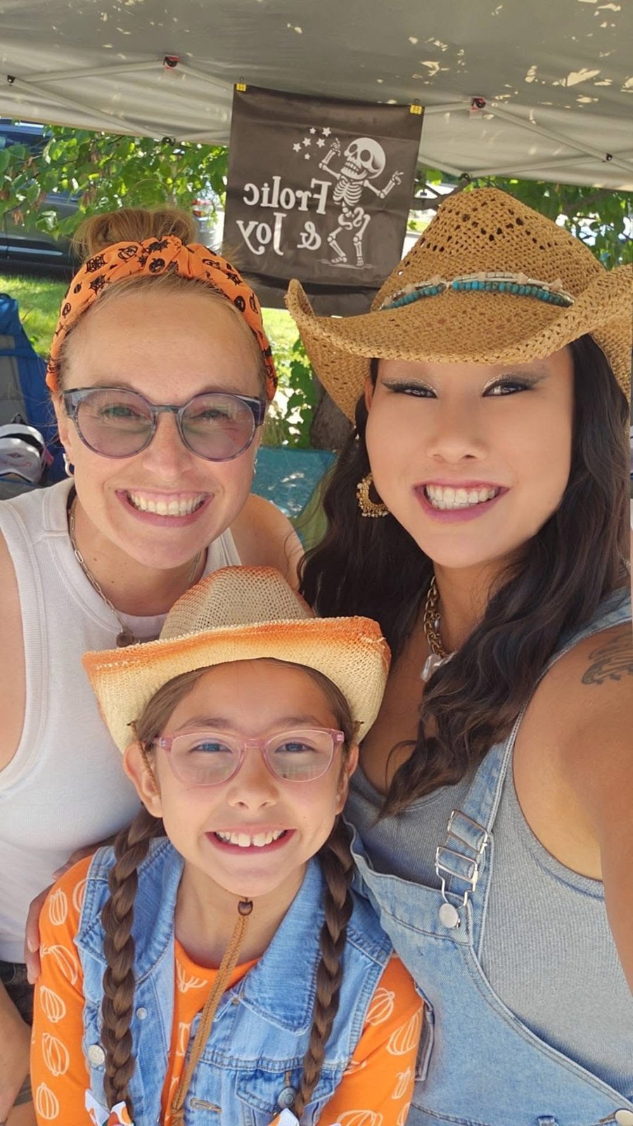 Chiara, Hayley and Alora smiling at the Frolic and Joy market booth